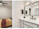 Contemporary bathroom featuring modern vanity with black fixtures, white countertops, and convenient bedroom access at 4025 Jason St # 101, Denver, CO 80211
