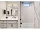 Bright bathroom featuring a shower over a bathtub with white tiling and a modern vanity with a sleek black faucet at 4025 Jason St # 101, Denver, CO 80211