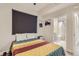 Bright bedroom with ensuite bath access featuring hardwood floors, and a large window for natural light at 4025 Jason St # 101, Denver, CO 80211