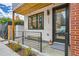 Inviting entrance with a cozy bench, fresh flowers, and modern black door at 4025 Jason St # 101, Denver, CO 80211