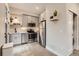 Modern kitchen with stainless steel appliances, gray cabinets, and stylish lighting at 4025 Jason St # 101, Denver, CO 80211