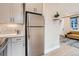 Open-concept kitchen featuring stainless steel appliances, modern cabinets, and seamless flow to the living area at 4025 Jason St # 101, Denver, CO 80211