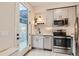 Modern kitchen with stainless steel appliances, sleek gray cabinetry, and natural lighting at 4025 Jason St # 101, Denver, CO 80211