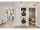 Efficient laundry area with stacked washer and dryer, conveniently located near the kitchen and bedroom for easy access at 4025 Jason St # 101, Denver, CO 80211