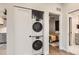 Space-saving laundry area with stacked washer and dryer, situated near the bedroom and bathroom, offering ease and efficiency at 4025 Jason St # 101, Denver, CO 80211