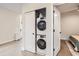 Convenient laundry area with a stacked washer and dryer unit, maximizing space and adding functionality to the home at 4025 Jason St # 101, Denver, CO 80211