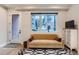 Cozy living area featuring a black-and-white rug, light-colored walls, and comfortable seating at 4025 Jason St # 101, Denver, CO 80211