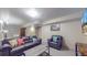Spacious basement area with seating and entertainment setup at 7081 Warren Dr, Denver, CO 80221