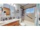 Updated bathroom features tiled shower over tub and neutral colored vanity at 7081 Warren Dr, Denver, CO 80221