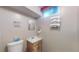 Bathroom features a toilet, vanity, and organized towel rack at 7081 Warren Dr, Denver, CO 80221