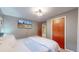 Comfortable bedroom highlighting neutral walls and a wooden door at 7081 Warren Dr, Denver, CO 80221