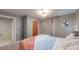 Bright bedroom showing a double bed, gray walls, and neutral curtains at 7081 Warren Dr, Denver, CO 80221
