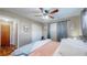 Bright bedroom features a ceiling fan, closet, and stylish decor at 7081 Warren Dr, Denver, CO 80221