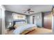A bright, well-lit bedroom features carpet floors, a ceiling fan, and a large closet space at 7081 Warren Dr, Denver, CO 80221