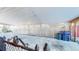 Spacious carport area with a concrete floor and white lattice siding at 7081 Warren Dr, Denver, CO 80221