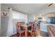 Stylish dining area with hardwood floors, natural light, and a view into the updated kitchen, ideal for Gathering meals at 7081 Warren Dr, Denver, CO 80221