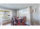 Bright dining area with hardwood floors, offering natural light and a cozy space for meals, adding to the home's charm at 7081 Warren Dr, Denver, CO 80221
