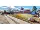 Charming brick home with a well-manicured lawn, mature trees, and inviting curb appeal at 7081 Warren Dr, Denver, CO 80221