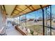 Inviting covered front porch with decorative ironwork and a well-maintained garden bed at 7081 Warren Dr, Denver, CO 80221