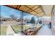 Charming covered front porch with decorative ironwork and a well-maintained garden bed at 7081 Warren Dr, Denver, CO 80221