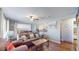 Inviting living area with hardwood floors, a ceiling fan, and a view into the modern kitchen, creating a cozy atmosphere at 7081 Warren Dr, Denver, CO 80221