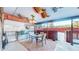 Covered patio featuring a dining table, chairs, decorative ceiling, and privacy features at 7081 Warren Dr, Denver, CO 80221