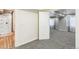 Finished basement area leads to bedroom and bathroom with carpet and adjacent shower at 7400 W Grant Ranch Blvd # 52, Littleton, CO 80123