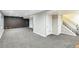 Large finished basement area with carpet flooring, neutral paint, and access to stairs at 7400 W Grant Ranch Blvd # 52, Littleton, CO 80123
