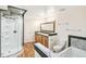 Beautiful bathroom with glass shower, double sinks, custom mirror, bath tub and tile flooring at 7400 W Grant Ranch Blvd # 52, Littleton, CO 80123