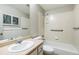 Well-lit bathroom features a shower over tub with tiled walls, neutral color palette, and a vanity at 7400 W Grant Ranch Blvd # 52, Littleton, CO 80123