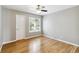 Bright bedroom with hardwood floors, ceiling fan, and natural light from the window at 7400 W Grant Ranch Blvd # 52, Littleton, CO 80123