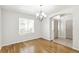 Spacious dining room with hardwood floors, natural light, and a modern chandelier at 7400 W Grant Ranch Blvd # 52, Littleton, CO 80123