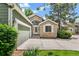 Charming home featuring stone accents, a well-manicured lawn, and an attached two-car garage at 7400 W Grant Ranch Blvd # 52, Littleton, CO 80123