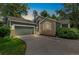 Charming home featuring stone accents, a well-manicured lawn, and an attached two-car garage at dusk at 7400 W Grant Ranch Blvd # 52, Littleton, CO 80123