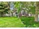 Well-maintained home exterior with green siding, a lush lawn, and mature trees at 7400 W Grant Ranch Blvd # 52, Littleton, CO 80123