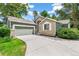 Charming home featuring stone accents, a well-manicured lawn, and an attached two-car garage at 7400 W Grant Ranch Blvd # 52, Littleton, CO 80123