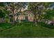 Charming home with a lush green lawn and mature trees providing shade at 7400 W Grant Ranch Blvd # 52, Littleton, CO 80123
