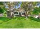 Charming home with a lush green lawn and mature trees providing shade at 7400 W Grant Ranch Blvd # 52, Littleton, CO 80123