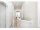 Bright hallway with tiled flooring and vaulted ceilings featuring archways and a set of french doors at 7400 W Grant Ranch Blvd # 52, Littleton, CO 80123
