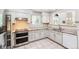 Kitchen with stainless steel oven, granite countertops, and white cabinets at 7400 W Grant Ranch Blvd # 52, Littleton, CO 80123