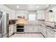 Charming kitchen featuring stainless appliances, granite counters and bright, natural light at 7400 W Grant Ranch Blvd # 52, Littleton, CO 80123
