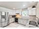 Well-lit kitchen with stainless steel appliances, granite countertops, and white cabinets at 7400 W Grant Ranch Blvd # 52, Littleton, CO 80123