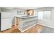 Bright basement kitchenette features stone accents, a small fridge, tile counters, and wooden cabinets at 7400 W Grant Ranch Blvd # 52, Littleton, CO 80123