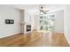 Bright living room with a fireplace, hardwood floors, and a sliding glass door to the outside deck at 7400 W Grant Ranch Blvd # 52, Littleton, CO 80123
