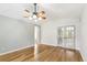 Spacious living room with hardwood floors, ceiling fan, and french doors at 7400 W Grant Ranch Blvd # 52, Littleton, CO 80123