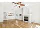 Bright living room with a fireplace and hardwood floors open to the kitchen at 7400 W Grant Ranch Blvd # 52, Littleton, CO 80123