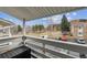 This balcony offers a tranquil view of community landscaping and parking area with plenty of trees and blue sky at 8555 Fairmount Dr # B202, Denver, CO 80247