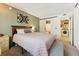 Comfortable bedroom featuring a modern barn door leading to the bathroom and laundry area at 8555 Fairmount Dr # B202, Denver, CO 80247