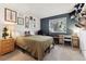 Well-lit bedroom with an accent wall, decorated with picture frames, offering a comfortable space at 8555 Fairmount Dr # B202, Denver, CO 80247