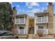 Charming condo exterior with balconies, stone accents, and yellow siding offering a cozy residential feel at 8555 Fairmount Dr # B202, Denver, CO 80247
